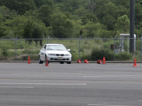 2001 Mercury Grand Marquis - A white sedan is parked on a paved lot with orange cones around it.