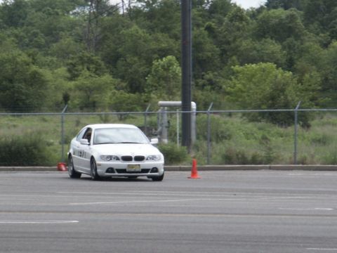 2001 Mercury Grand Marquis - A white BMW coupe navigates a course marked by orange cones.