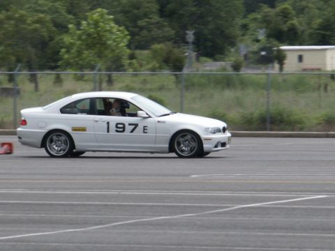 2001 Mercury Grand Marquis - White BMW E46 coupe with racing numbers on a track.