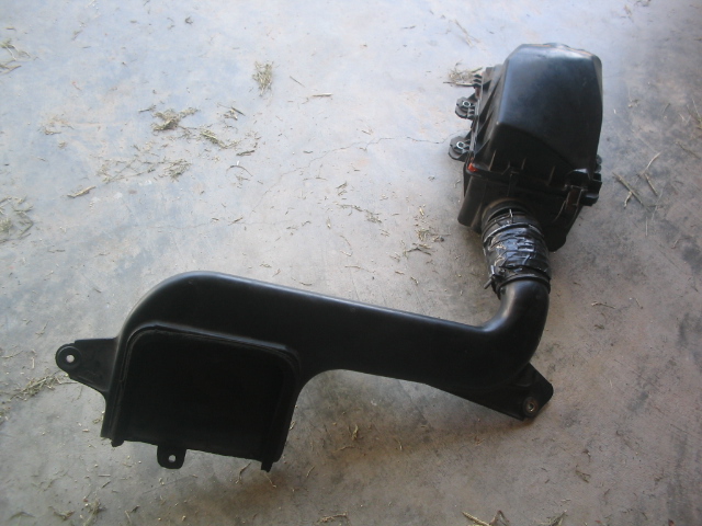 Black air intake assembly on concrete floor