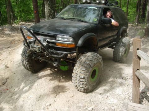 1995 Ford Bronco - This modified SUV is equipped for off-road adventures with its aggressive tires and custom bumper.