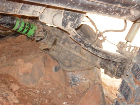1995 Ford Bronco - Close-up of the rear axle and suspension system, showing wear and tear from off-road use.