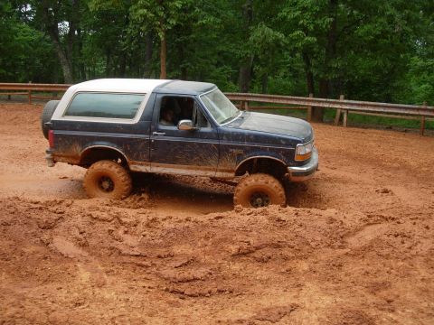 1995 Ford Bronco - This 1995 Ford Bronco is navigating a muddy trail with its tires deep in the muck.