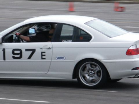 2001 Mercury Grand Marquis - White BMW E46 coupe on track, showing racing numbers and driver.