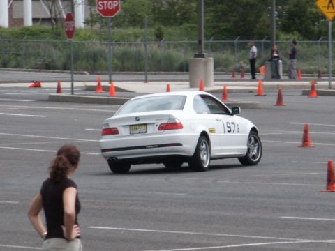 2001 Mercury Grand Marquis - A white BMW coupe navigates a course marked by orange cones, displaying the number 197 on its door.