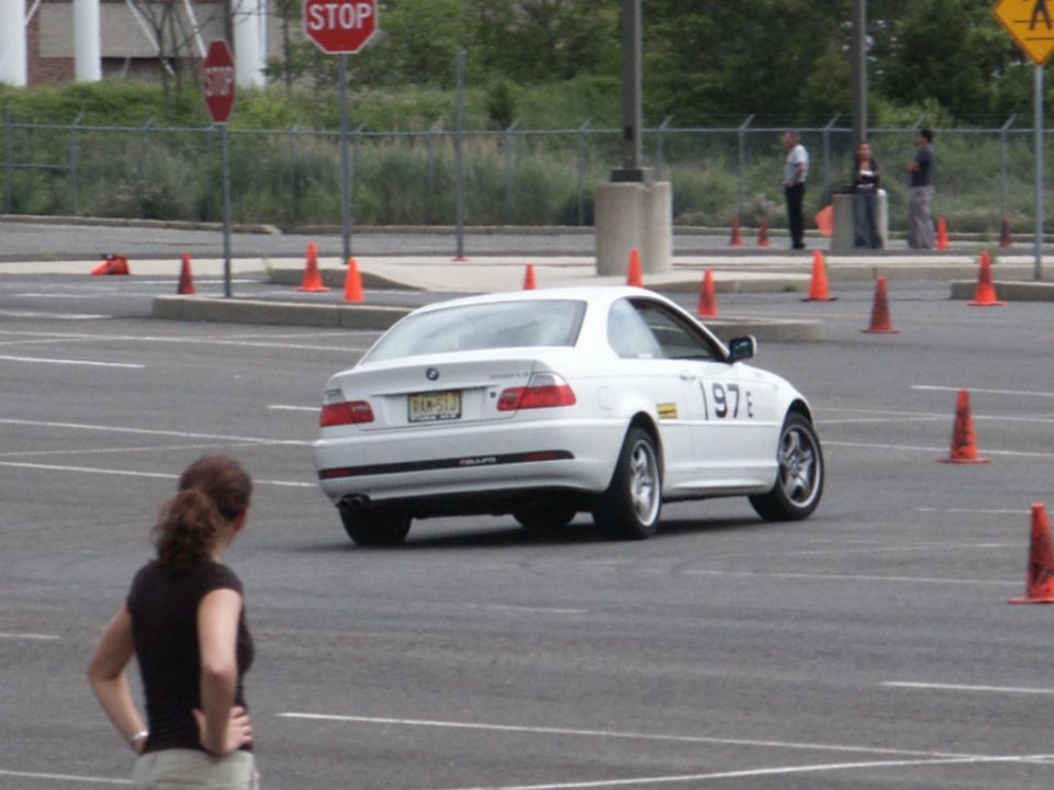 White BMW coupe with racing number 197 on side, rear view