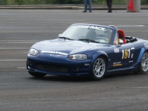 2001 Mercury Grand Marquis - A blue convertible sports car with racing decals is on a track.