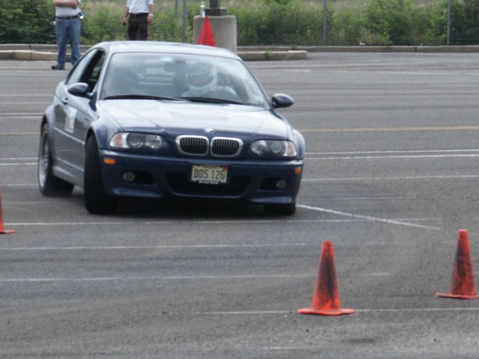 Blue BMW coupe with license plate DDS 126, front view, on asphalt with orange cones
