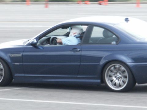 2001 Mercury Grand Marquis - Driver in helmet steers a blue coupe during what looks like a track day event.