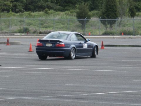 2001 Mercury Grand Marquis - Blue BMW coupe on a track, possibly during a timed event.