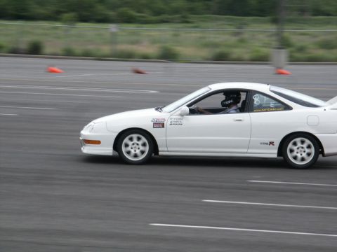 2001 Mercury Grand Marquis - A white Acura Integra Type R is shown on a race track with orange cones in the background.
