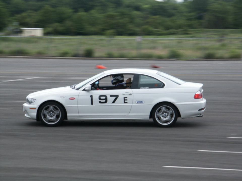 Side view of white coupe with racing number 197E on door