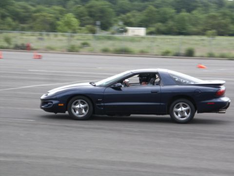 2001 Mercury Grand Marquis - A blue Pontiac Firebird is seen driving on a track, possibly during an event.