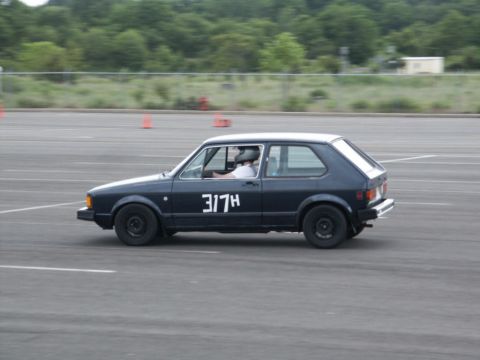 2001 Mercury Grand Marquis - Hatchback car with racing number 317H on side, participating in an event on a paved track.