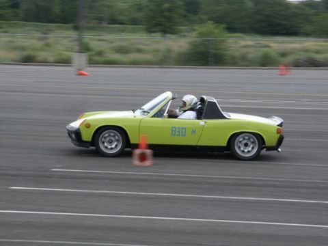 2001 Mercury Grand Marquis - A driver in a lime green convertible navigates a course marked by orange cones.
