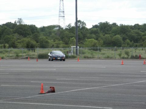 2001 Mercury Grand Marquis - Pontiac Firebird navigates an autocross course marked by orange cones.