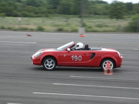 2001 Mercury Grand Marquis - Red convertible sports car with racing number 190 on the door is seen on a track.