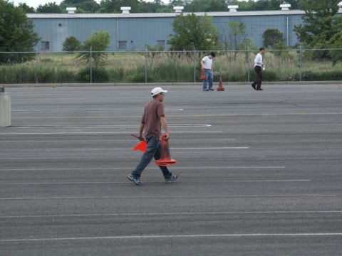 2001 Mercury Grand Marquis - People are seen in a large, empty parking lot with traffic cones.