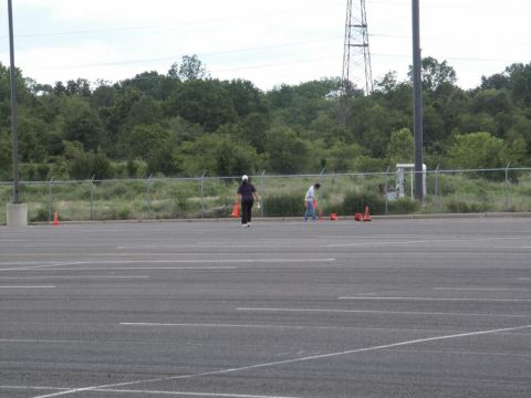 2001 Mercury Grand Marquis - A parking lot scene with two people and several traffic cones visible in the background.