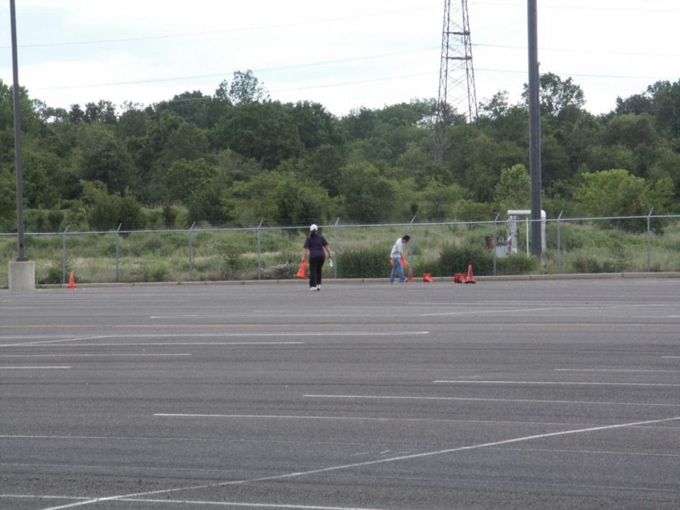 Parking lot scene with people and traffic cones