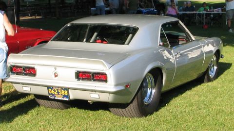 1994 Ford Bronco - This silver coupe, likely a 1967 Chevrolet Camaro, is equipped with a roll cage and drag racing tires.