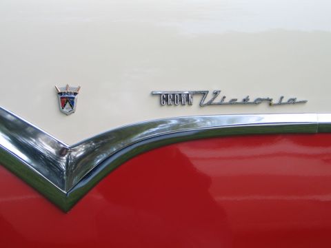 1994 Ford Bronco - Close-up of a Ford emblem and Crown Victoria script on a vintage car.