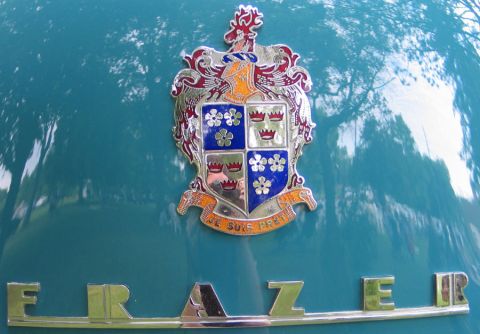 1994 Ford Bronco - A close-up of a car's hood displays a crest emblem and the name FRAZER in chrome lettering.