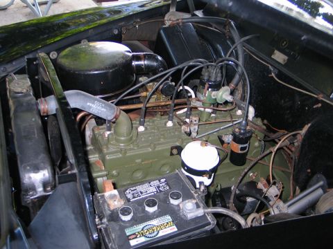 1994 Ford Bronco - Close-up view of an engine bay, showing the engine block, air cleaner, and battery.