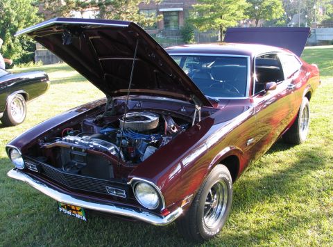 1994 Ford Bronco - This classic Ford Maverick is displayed with its hood and trunk open, revealing the engine bay and interior.
