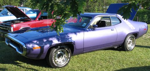 1994 Ford Bronco - A purple 1971 Plymouth Road Runner is parked on grass next to other vehicles.
