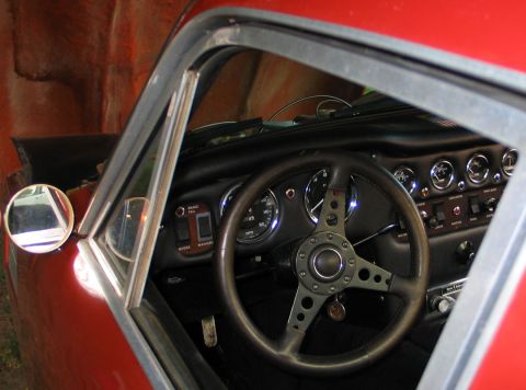 1994 Ford Bronco - Car interior with a classic steering wheel and dashboard gauges visible.