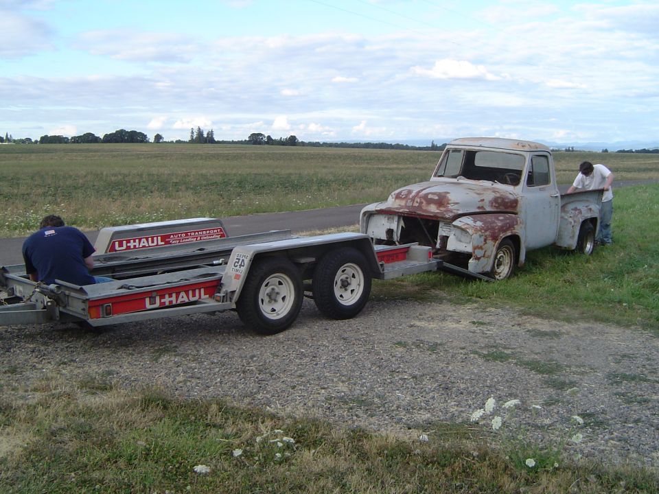 Rusty 1956 pickup truck on U-Haul trailer