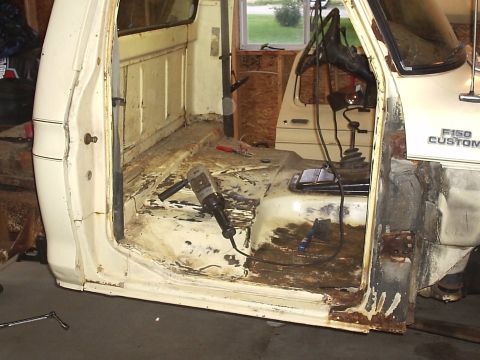 1979 Ford F-150 - The interior of a 1979 Ford F-150 Custom cab shows significant rust and is equipped with tools for body work.