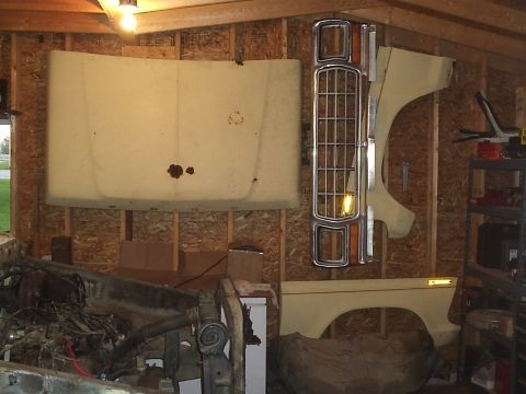 1979 Ford F-150 - Various body parts for a 1979 Ford F-150 are stored in a garage.