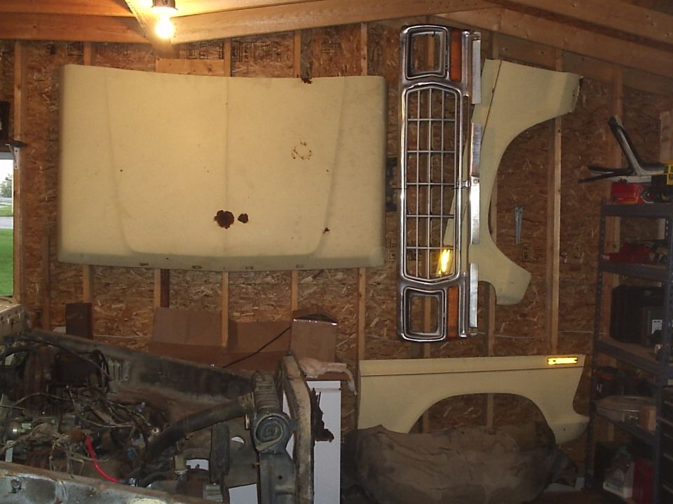 1979 Ford F-150 hood, grille, fender, and fender flare hanging on wall
