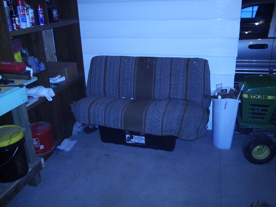 Bench seat in garage with a John Deere STX38 lawn tractor to the right