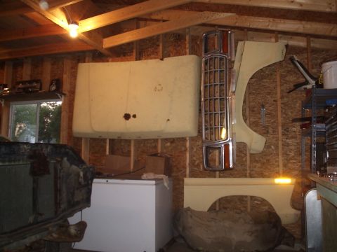 1979 Ford F-150 - Various vehicle body parts are stored and displayed on the walls of a workshop.