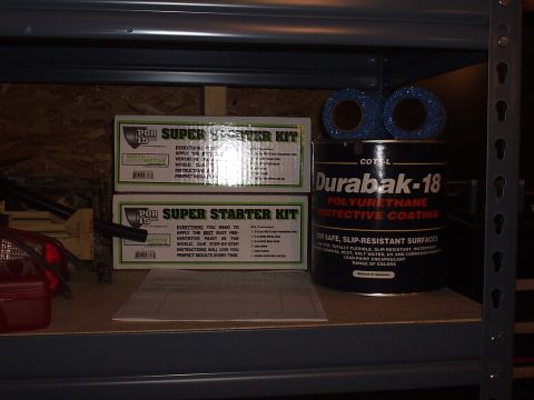 1979 Ford F-150 - Automotive repair supplies including POR-15 kits and Durabak-18 coating are stored on a shelf.