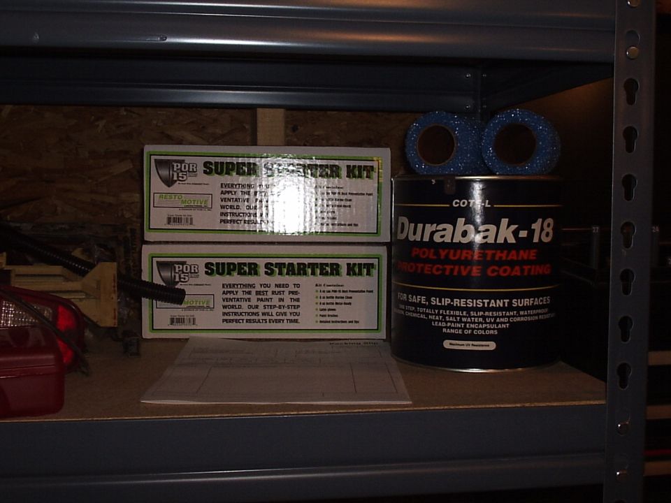 Two POR-15 Super Starter Kits and a can of Durabak-18 protective coating on a shelf