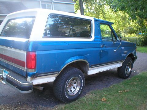 1989 Ford Bronco - This 1989 Ford Bronco is shown from the rear three-quarter angle, parked outdoors.