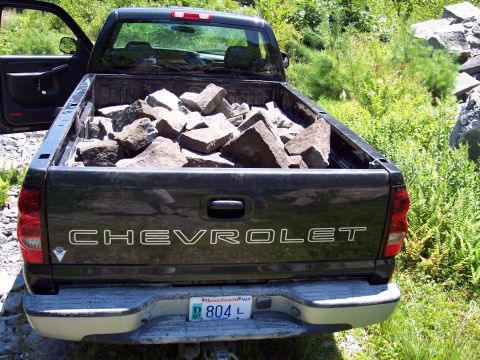 2001 Ford Crown Victoria - Chevrolet pickup truck bed filled with rocks, seen from the rear. Massachusetts license plate visible.