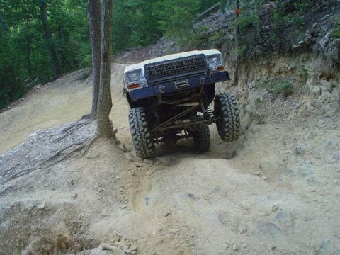 1992 Ford Mustang - An off-road vehicle navigates a challenging rocky trail.