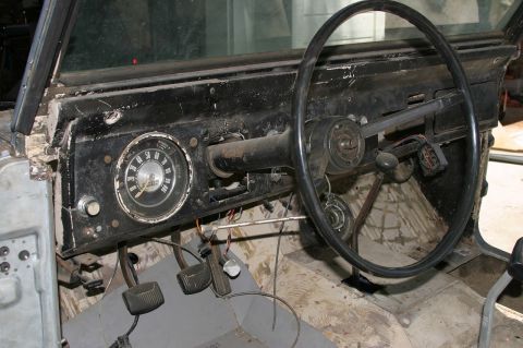 1971 Ford Bronco - The interior of a 1971 Ford Bronco, viewed from the passenger side, reveals the dashboard and steering wheel.