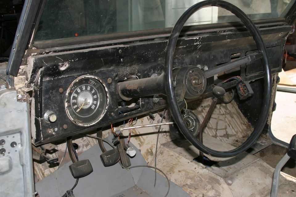 1971 Ford Bronco interior showing dashboard, steering wheel, and pedals
