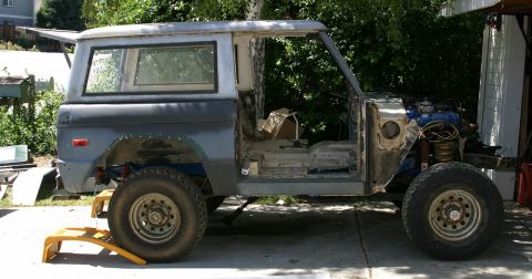 1971 Ford Bronco - This 1971 Ford Bronco is undergoing restoration, with its doors removed and the engine compartment visible.
