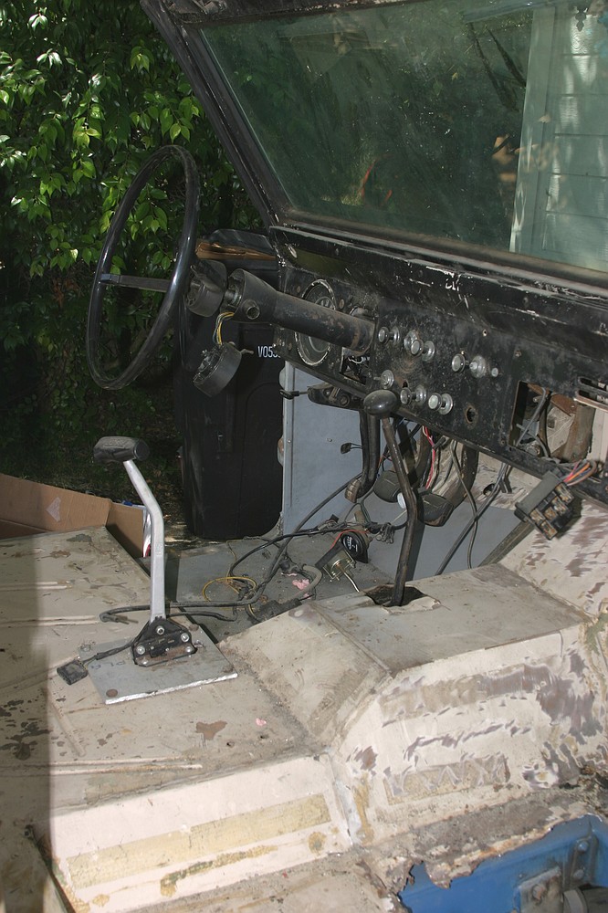 1971 Ford Bronco interior showing dashboard, steering wheel, and floor shifter