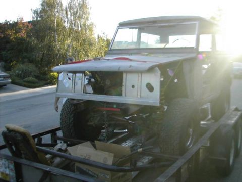 1971 Ford Bronco - This 1971 Ford Bronco is being transported on a trailer, showing its front end with the hood off.