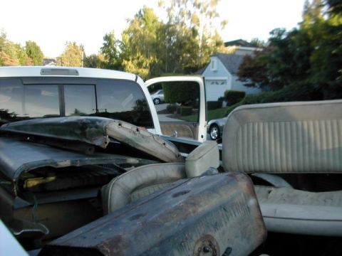 1971 Ford Bronco - The truck bed is filled with various automotive parts, obscuring the vehicle itself.