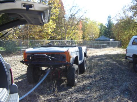 1971 Ford Bronco - A classic Ford Bronco is parked outdoors with a winch cable connected to its front bumper.
