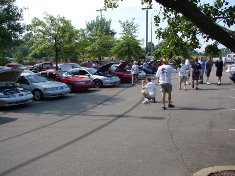 1992 Ford Taurus - A gathering of Ford Taurus sedans, likely a car show, with attendees observing the vehicles.